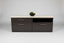 Black and beige low lateral storage with a plant on a neutral background
