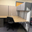 Office cubicle with a desk, chair, and filing cabinet in an office setting.