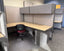 Corner office desk with partitioned workstations in an office setting